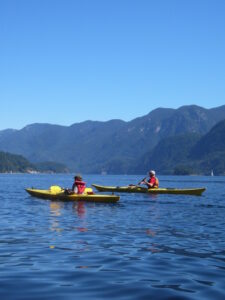Two kids kayaking on sunny day