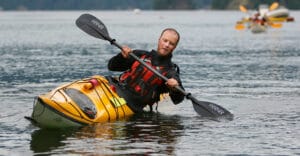 Man Edges and braces in kayak