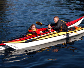 instructor helping kayaker remount her boat