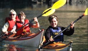 Three women kayaking recreationally