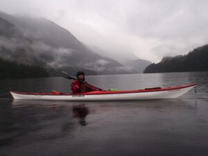 Person kayaking in the rain - full size