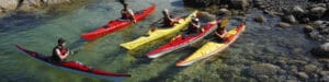 4 Kayakers being taught by an instructor